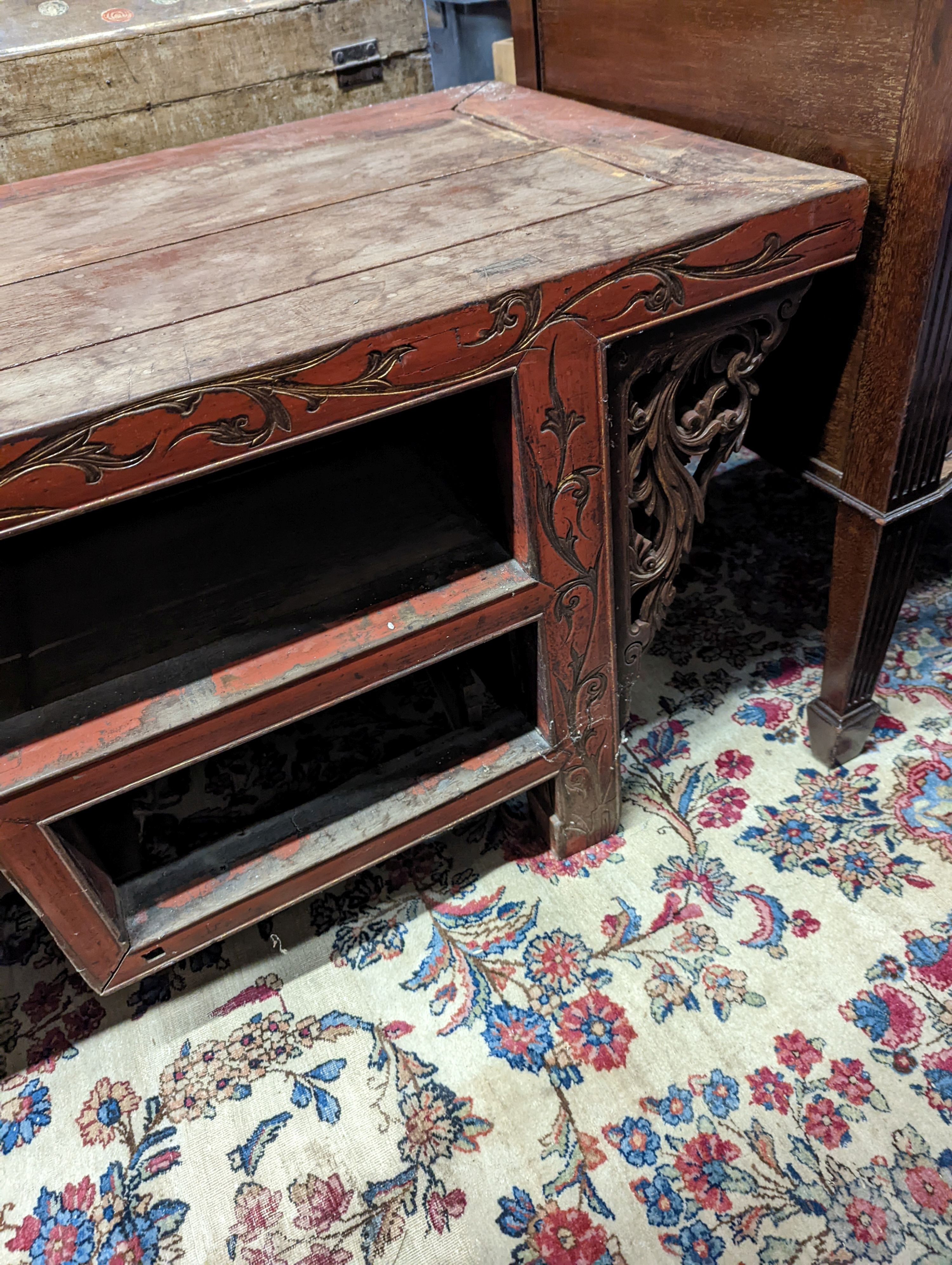 A Chinese red lacquer hardwood low altar table, width 240cm depth 56cm height 56cm